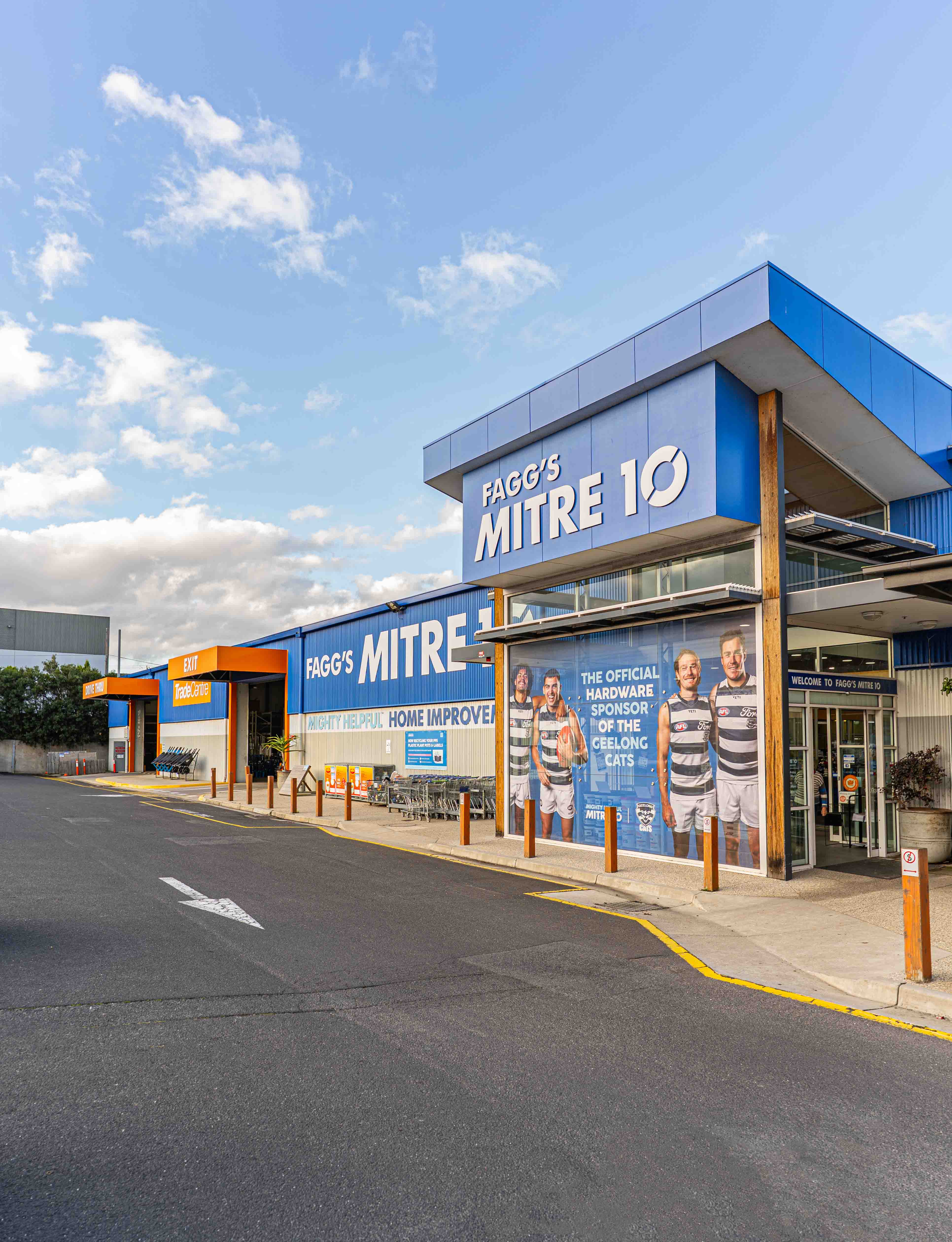 Exterior view of Fagg's Mitre 10 hardware store with clear sky.